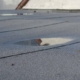 Ponding rainwater on flat roof after rain, roof drainage and leak problem