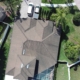 Aerial drone image of a residential house near Tampa Florida with screen enclosure protecting pool_