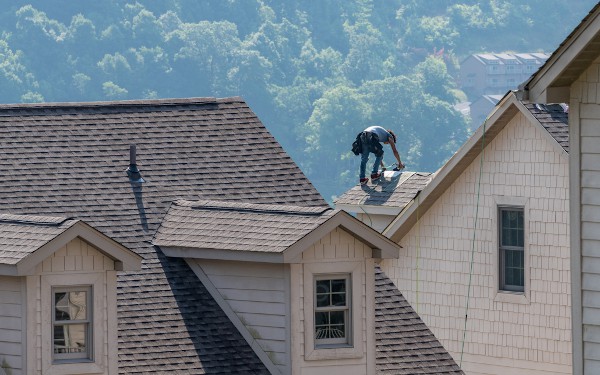 roofing contractor working on roof